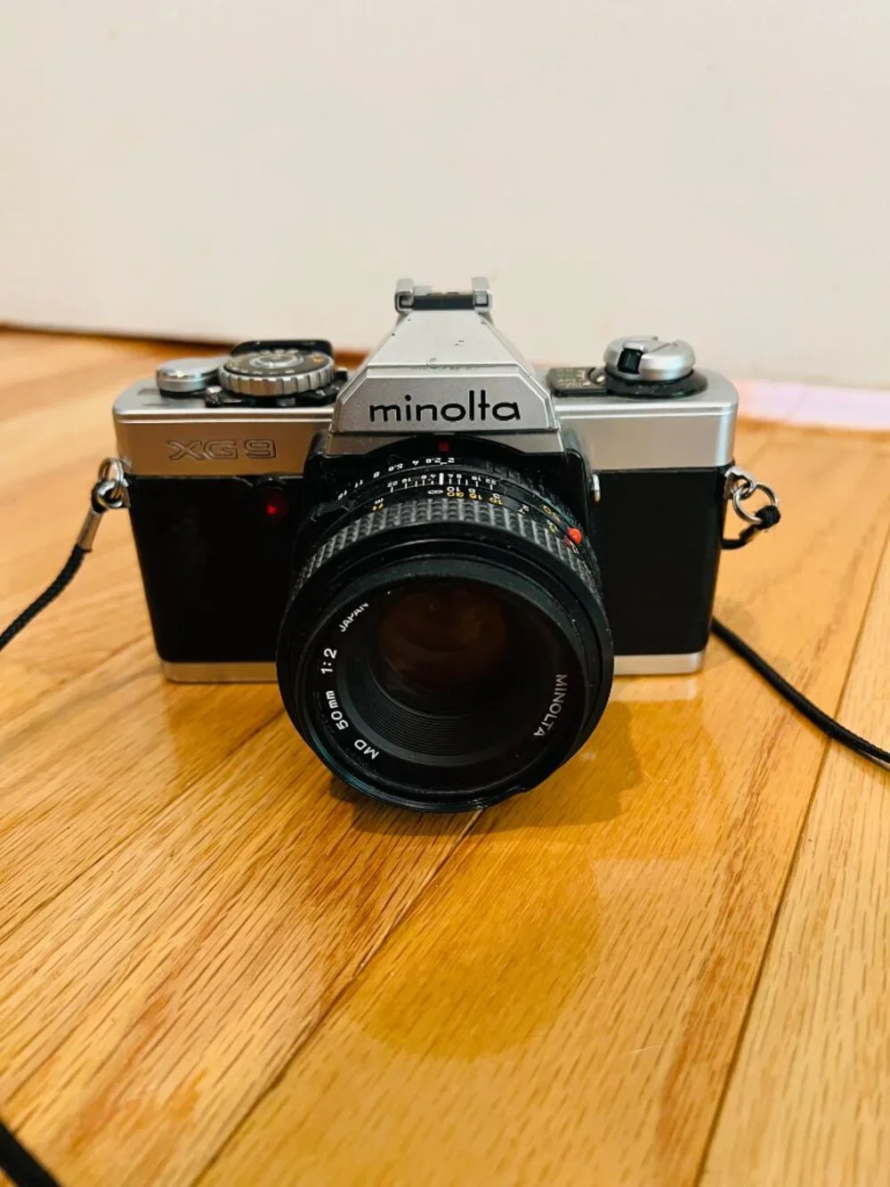 vintage Minolta XG-9 35mm SLR film camera equipped with a 50mm prime lens